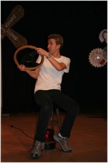 Brent Bishop steers out of control after a disastrous party. In the premiere production, pieces of the whirligigs in the background were used as all the props in the play.